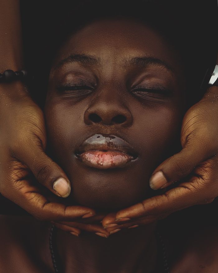 The Art of Drawing Readers In: Your attractive post title goes here Close-up of an African woman with eyes closed, surrounded by caring hands.